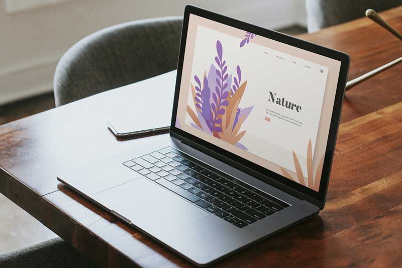 Laptop mockup on a wooden table in a meeting room
