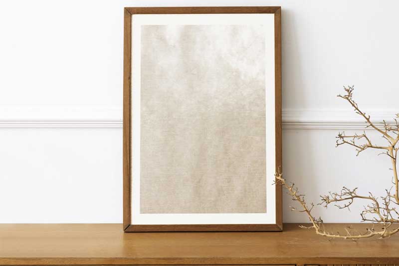 Picture frame mockup on a wooden sideboard table